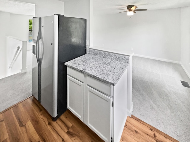2620 Trailwind St, Grove City, OH 43123 - kitchen featuring stainless steel fridge with ice dispenser, a ceiling fan, dark wood finished floors, light stone countertops, and baseboards