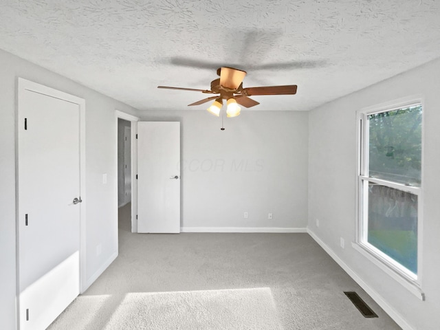 2620 Trailwind St, Grove City, OH 43123 - unfurnished bedroom with baseboards, carpet floors, ceiling fan, and a textured ceiling