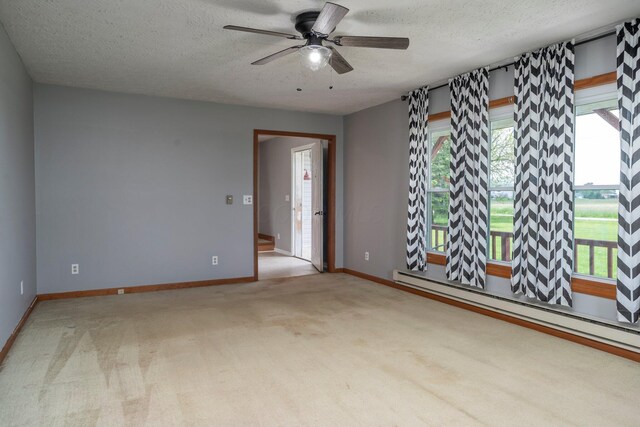 13216 Sheley Road Nw, Jeffersonville, OH 43128 - empty room featuring a baseboard radiator, a textured ceiling, a ceiling fan, carpet flooring, and baseboards
