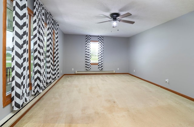 13216 Sheley Road Nw, Jeffersonville, OH 43128 - empty room with a baseboard radiator, baseboards, a ceiling fan, carpet floors, and a textured ceiling
