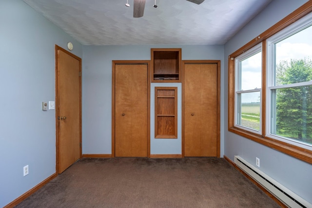 13216 Sheley Road Nw, Jeffersonville, OH 43128 - unfurnished bedroom featuring a baseboard heating unit, multiple windows, carpet floors, and baseboards