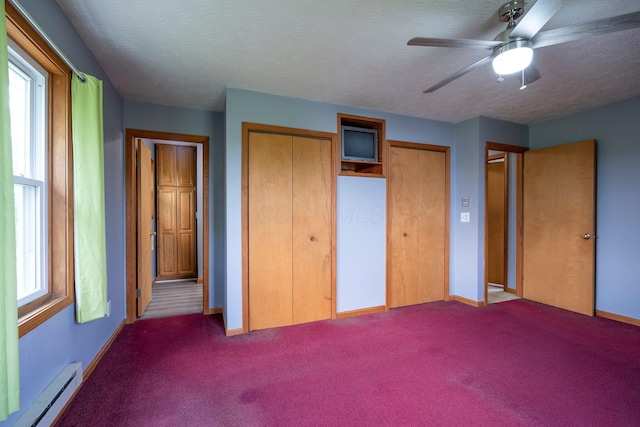 13216 Sheley Road Nw, Jeffersonville, OH 43128 - unfurnished bedroom with baseboard heating, carpet floors, a textured ceiling, two closets, and baseboards