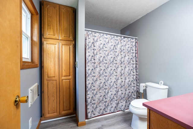 13216 Sheley Road Nw, Jeffersonville, OH 43128 - bathroom featuring wood finished floors, toilet, a shower with curtain, vanity, and a textured ceiling