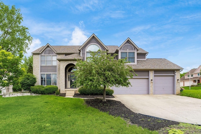 7936 Slate Ridge Blvd, Reynoldsburg, OH 43068 - traditional home with a front lawn, driveway, brick siding, roof with shingles, and a garage