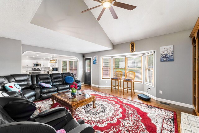 7936 Slate Ridge Blvd, Reynoldsburg, OH 43068 - living area with a ceiling fan, light wood-style floors, baseboards, and lofted ceiling