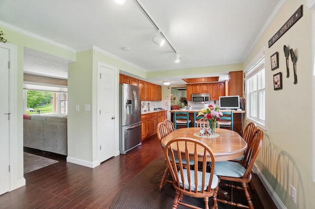 5336 Rocky Creek Dr, Grove City, OH 43123 - dining space with baseboards, dark wood-style floors, crown molding, and rail lighting