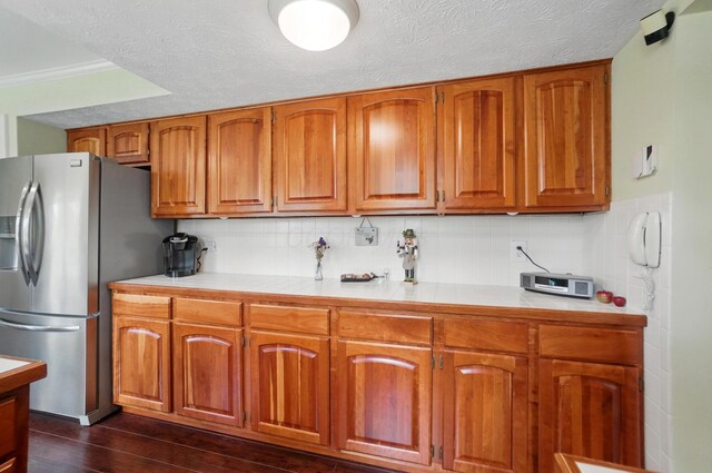 5336 Rocky Creek Dr, Grove City, OH 43123 - kitchen with brown cabinetry, stainless steel refrigerator with ice dispenser, dark wood-type flooring, tasteful backsplash, and crown molding