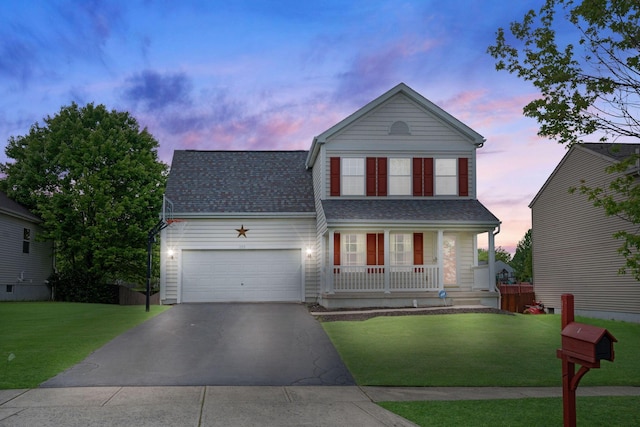 view of front of house featuring covered porch, driveway, an attached garage, a yard, and roof with shingles