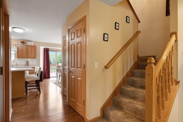 stairs with wood finished floors