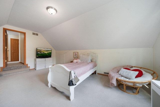 bedroom featuring vaulted ceiling, light colored carpet, and baseboards