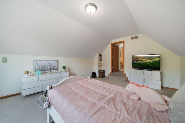 bedroom featuring light colored carpet, vaulted ceiling, and baseboards