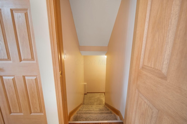 stairway featuring baseboards