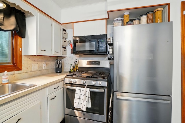 700 Taylor Blair Rd, West Jefferson, OH 43162 - kitchen with stainless steel appliances, white cabinetry, tasteful backsplash, light countertops, and a sink