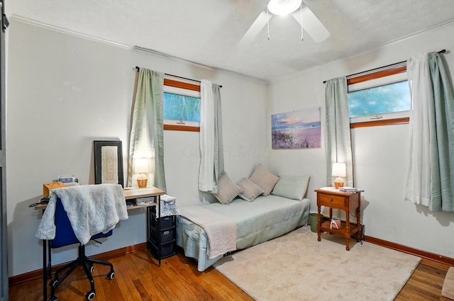 700 Taylor Blair Rd, West Jefferson, OH 43162 - bedroom featuring wood finished floors, ornamental molding, baseboards, a ceiling fan, and a desk