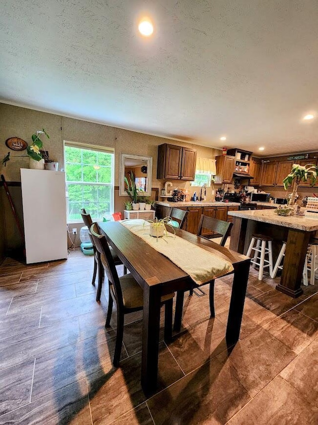 dining area featuring recessed lighting and a textured ceiling