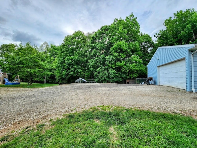 view of yard featuring an outbuilding and a garage