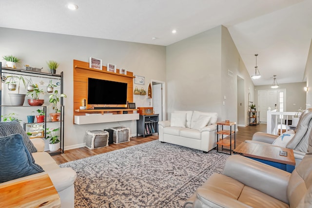 6922 Duke Dr, Canal Winchester, OH 43110 - living room featuring wood finished floors, baseboards, high vaulted ceiling, and recessed lighting
