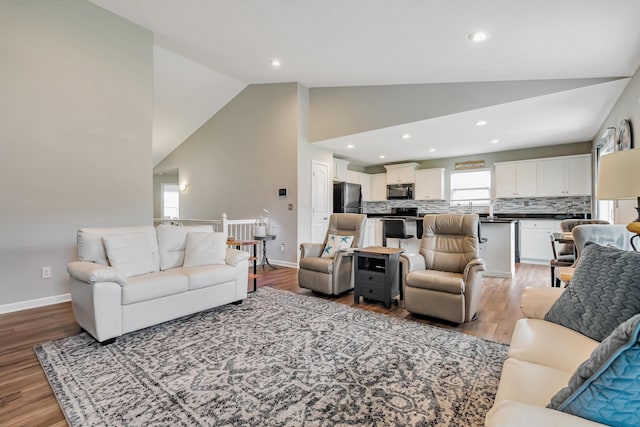 6922 Duke Dr, Canal Winchester, OH 43110 - living room featuring light wood-style flooring, baseboards, recessed lighting, and high vaulted ceiling
