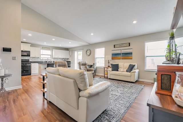 6922 Duke Dr, Canal Winchester, OH 43110 - living room with vaulted ceiling, light wood-style floors, baseboards, and recessed lighting