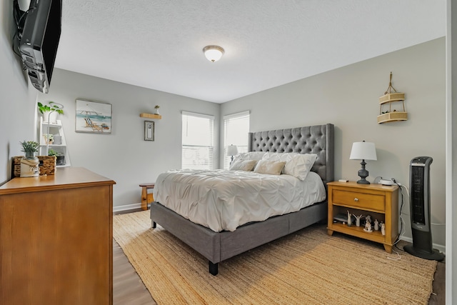 6922 Duke Dr, Canal Winchester, OH 43110 - bedroom featuring baseboards, light wood finished floors, and a textured ceiling