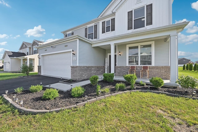 3321 Butternut Ln, Hebron, OH 43025 - view of front facade with brick siding, a porch, driveway, and an attached garage