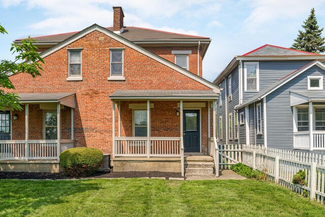 684 Hamlet St, Columbus, OH 43215 - view of front facade featuring a porch, brick siding, and a chimney