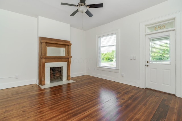 684 Hamlet St, Columbus, OH 43215 - unfurnished living room featuring hardwood / wood-style floors, ceiling fan, a fireplace with flush hearth, and baseboards