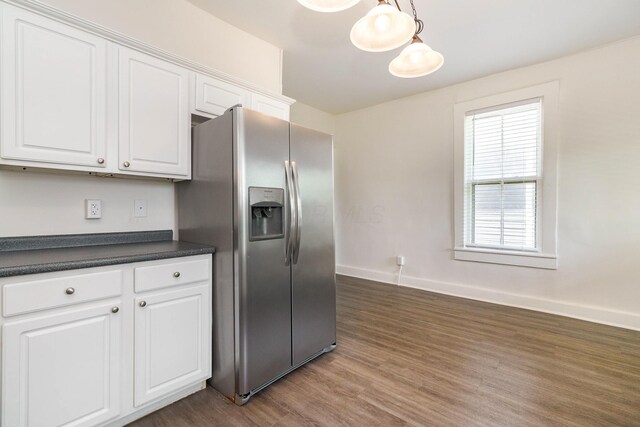 684 Hamlet St, Columbus, OH 43215 - kitchen with stainless steel fridge with ice dispenser, dark countertops, dark wood finished floors, white cabinetry, and baseboards