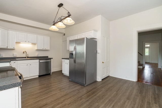 684 Hamlet St, Columbus, OH 43215 - kitchen with stainless steel appliances, dark wood-type flooring, white cabinets, dark countertops, and a sink