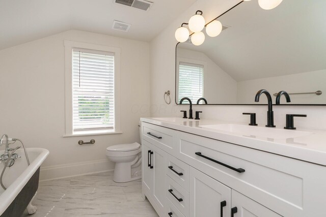 684 Hamlet St, Columbus, OH 43215 - full bath featuring vaulted ceiling, healthy amount of natural light, toilet, a freestanding tub, and marble look tiles