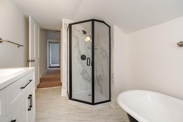684 Hamlet St, Columbus, OH 43215 - full bathroom with a marble finish shower, a freestanding bath, marble look tile flooring, vanity, and vaulted ceiling