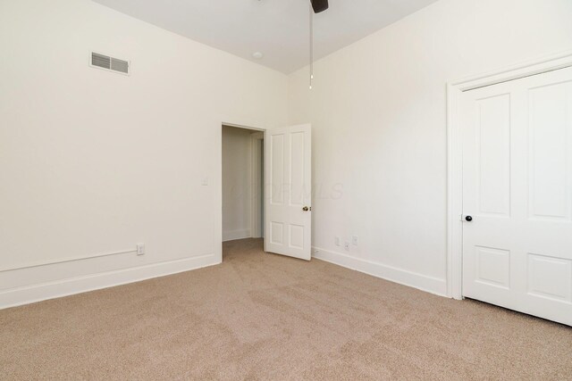 684 Hamlet St, Columbus, OH 43215 - unfurnished bedroom featuring light colored carpet, baseboards, and ceiling fan