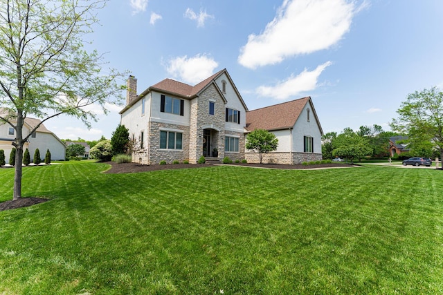 1338 Elkhorn Dr, Blacklick, OH 43004 - view of front of property featuring stucco siding, stone siding, a chimney, and a front lawn