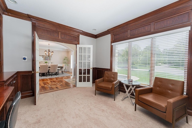 1338 Elkhorn Dr, Blacklick, OH 43004 - living area featuring crown molding, light colored carpet, arched walkways, wainscoting, and a chandelier