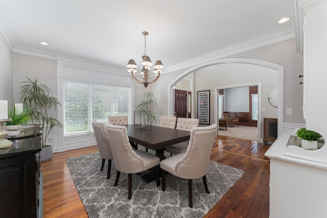 1338 Elkhorn Dr, Blacklick, OH 43004 - dining space featuring arched walkways, a chandelier, crown molding, dark wood-style flooring, and recessed lighting