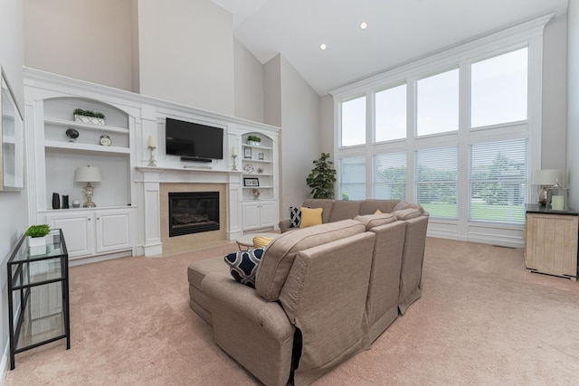 1338 Elkhorn Dr, Blacklick, OH 43004 - living room featuring high vaulted ceiling, light carpet, a fireplace with flush hearth, built in shelves, and recessed lighting