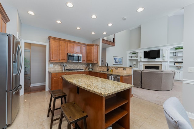 1338 Elkhorn Dr, Blacklick, OH 43004 - kitchen featuring stainless steel appliances, a sink, brown cabinets, a center island, and recessed lighting