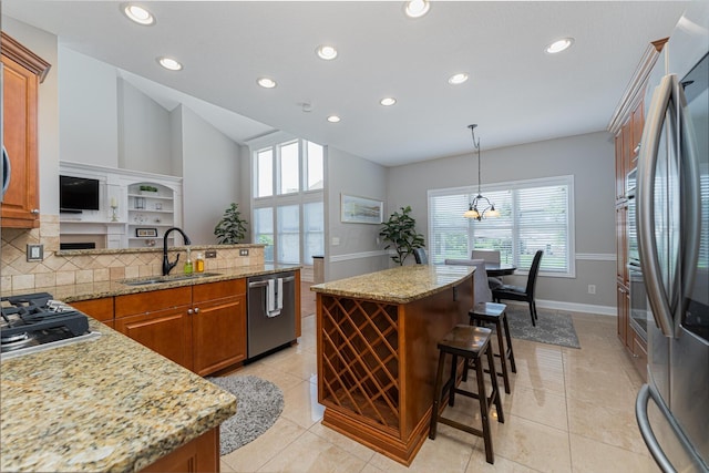 1338 Elkhorn Dr, Blacklick, OH 43004 - kitchen with a sink, stainless steel appliances, brown cabinets, recessed lighting, and a kitchen bar