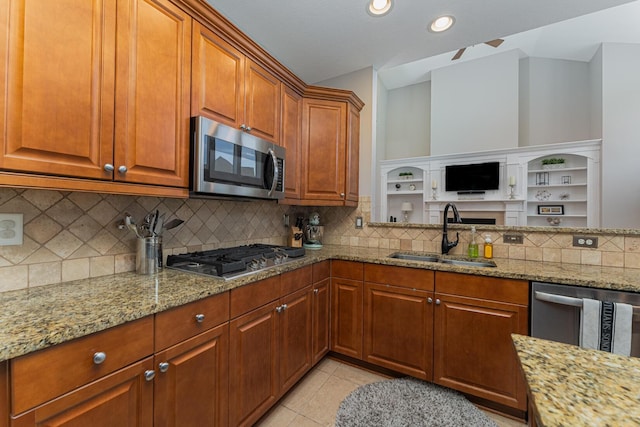 1338 Elkhorn Dr, Blacklick, OH 43004 - kitchen featuring a sink, appliances with stainless steel finishes, light stone countertops, backsplash, and brown cabinetry
