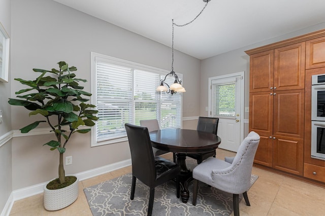 1338 Elkhorn Dr, Blacklick, OH 43004 - dining room with lofted ceiling, light tile patterned floors, and baseboards