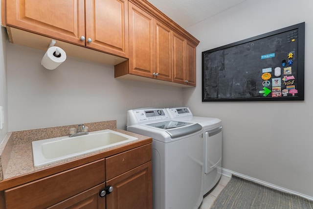 1338 Elkhorn Dr, Blacklick, OH 43004 - washroom with separate washer and dryer, cabinet space, light tile patterned floors, and baseboards