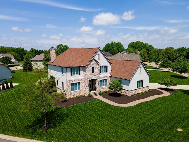 1338 Elkhorn Dr, Blacklick, OH 43004 - view of front of property with stone siding, stucco siding, a chimney, and a front lawn