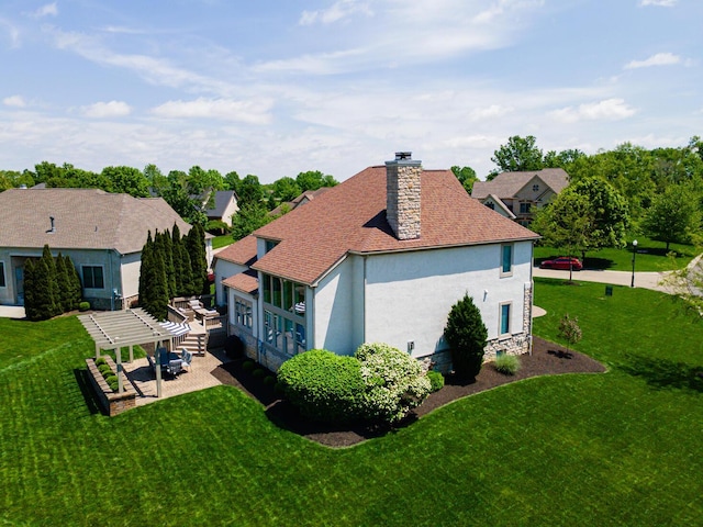 1338 Elkhorn Dr, Blacklick, OH 43004 - view of property exterior featuring stucco siding, a yard, a chimney, a patio, and a pergola