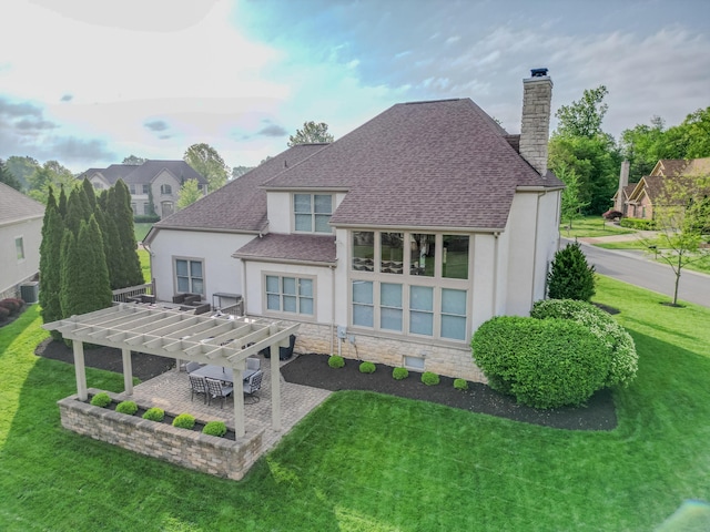 1338 Elkhorn Dr, Blacklick, OH 43004 - back of house featuring a pergola, stucco siding, a chimney, a patio, and a lawn