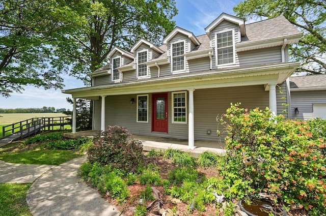 9820 Heimberger Rd NW, Baltimore, OH 43105 - view of front facade with covered porch, a shingled roof, and fence
