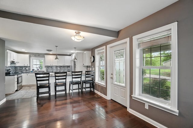 9820 Heimberger Rd NW, Baltimore, OH 43105 - kitchen with appliances with stainless steel finishes, backsplash, baseboards, a sink, and dark countertops