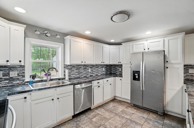 9820 Heimberger Rd NW, Baltimore, OH 43105 - kitchen with stainless steel appliances, a sink, decorative backsplash, white cabinetry, and dark countertops