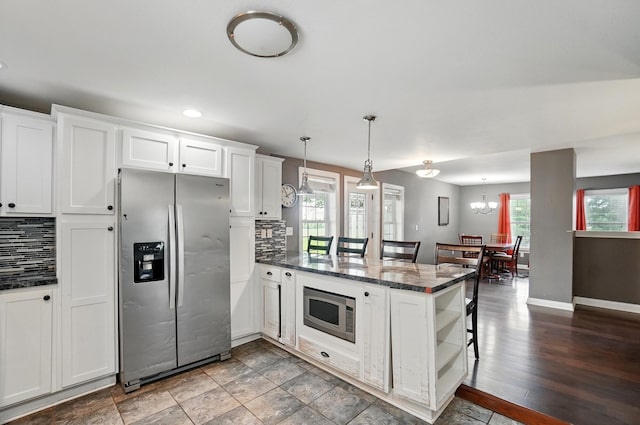 9820 Heimberger Rd NW, Baltimore, OH 43105 - kitchen featuring appliances with stainless steel finishes, a peninsula, open shelves, tasteful backsplash, and recessed lighting