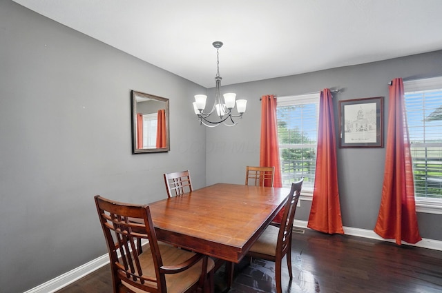 9820 Heimberger Rd NW, Baltimore, OH 43105 - dining area featuring a chandelier, dark wood-type flooring, and baseboards