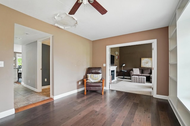 9820 Heimberger Rd NW, Baltimore, OH 43105 - sitting room with wood-type flooring, a ceiling fan, baseboards, and a fireplace
